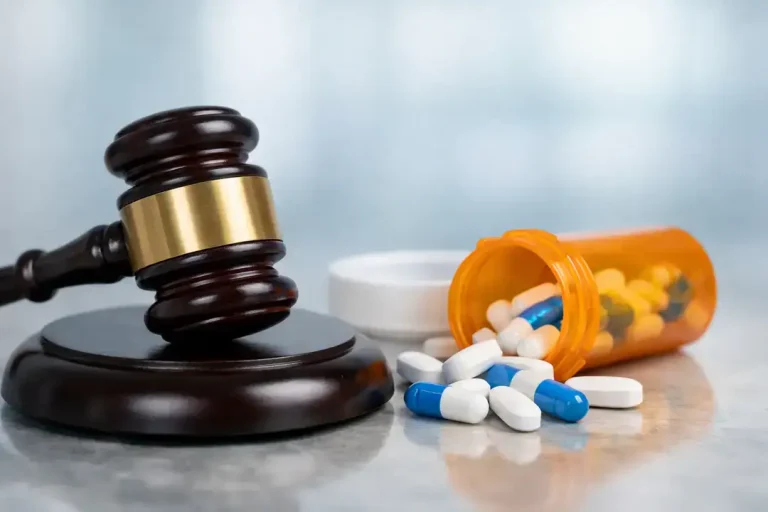 Judge gavel beside spilled pill bottle