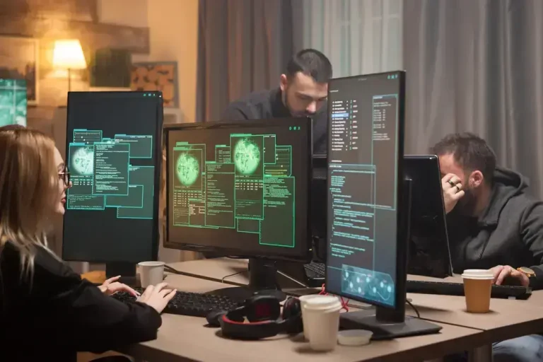Team working at computers with code screens